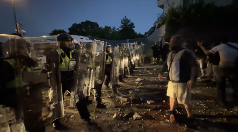 Riot Police Clash with Protesters Near Henry Nowak Stabbing Site